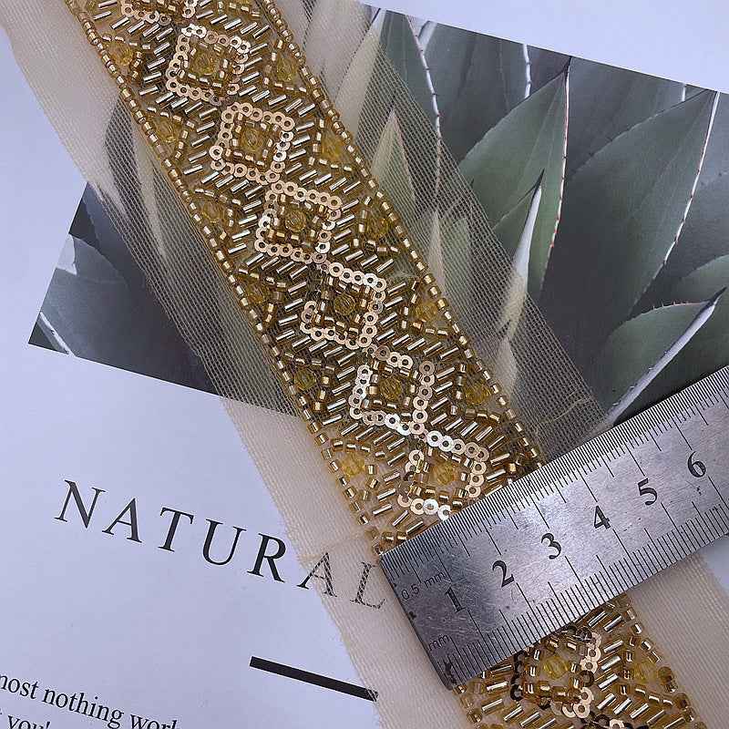 Gold mesh sequin lace trim with beading; 3.5 cm width shown by ruler
