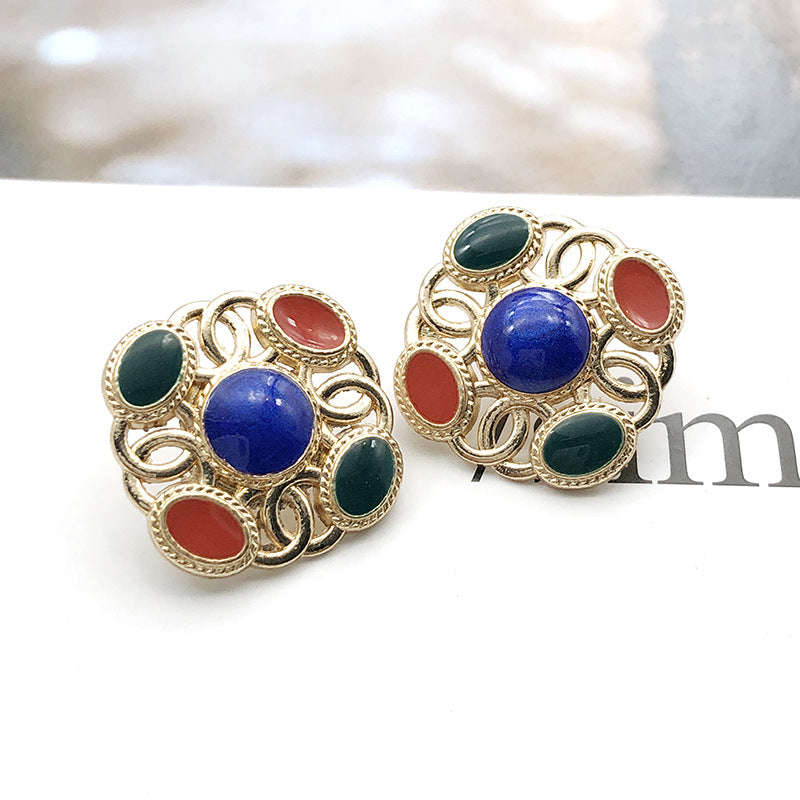 Square metal shank pearl buttons with blue center, green accents, and red oval pearls