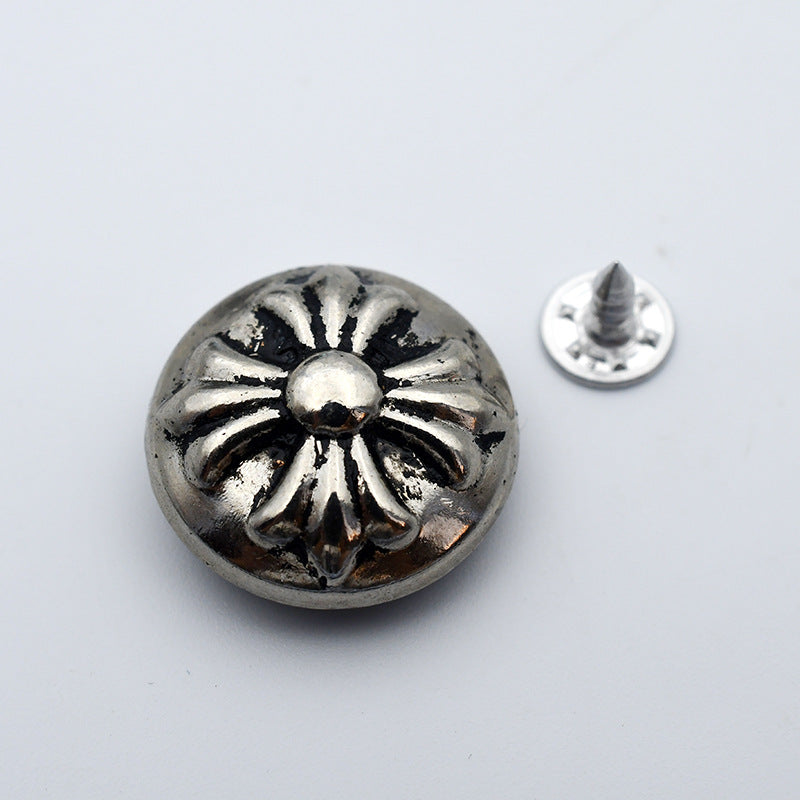 Round hollow metal stud button: silver with dark floral center and spike back