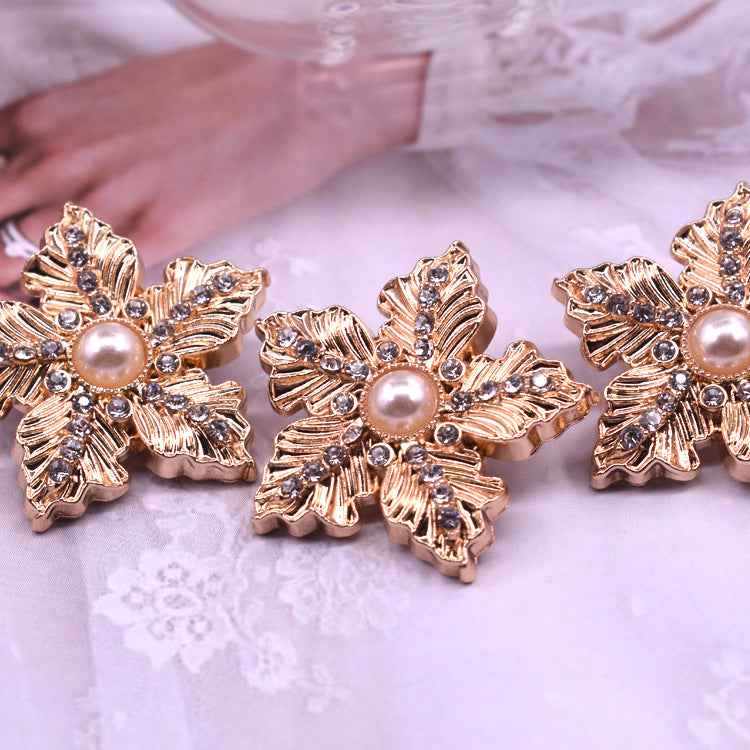 Set of gold snowflake buttons with faux pearl centers and crystal-like trim