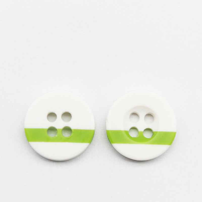 White round resin button with four holes and green stripe across the front