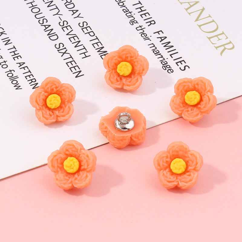 Orange flower plastic buttons, 13mm; yellow centers, silver backs