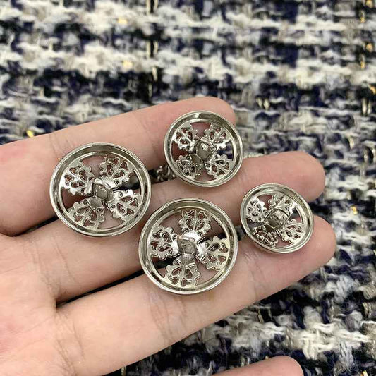 Set of round silver vintage hollow cross metal shank buttons, 4 shown in hand
