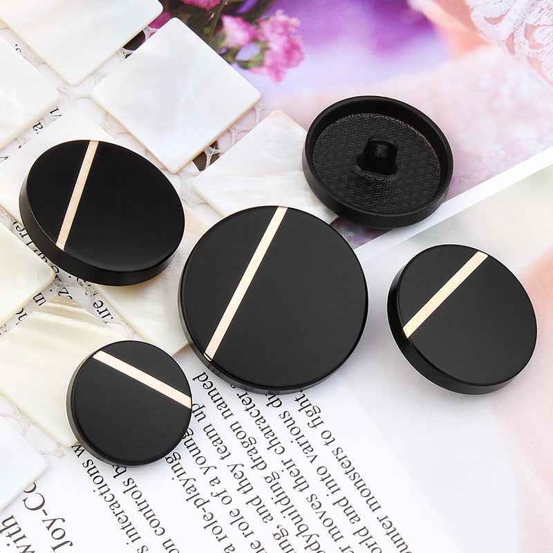 Pack of black round sewing buttons with metal shanks and gold stripes