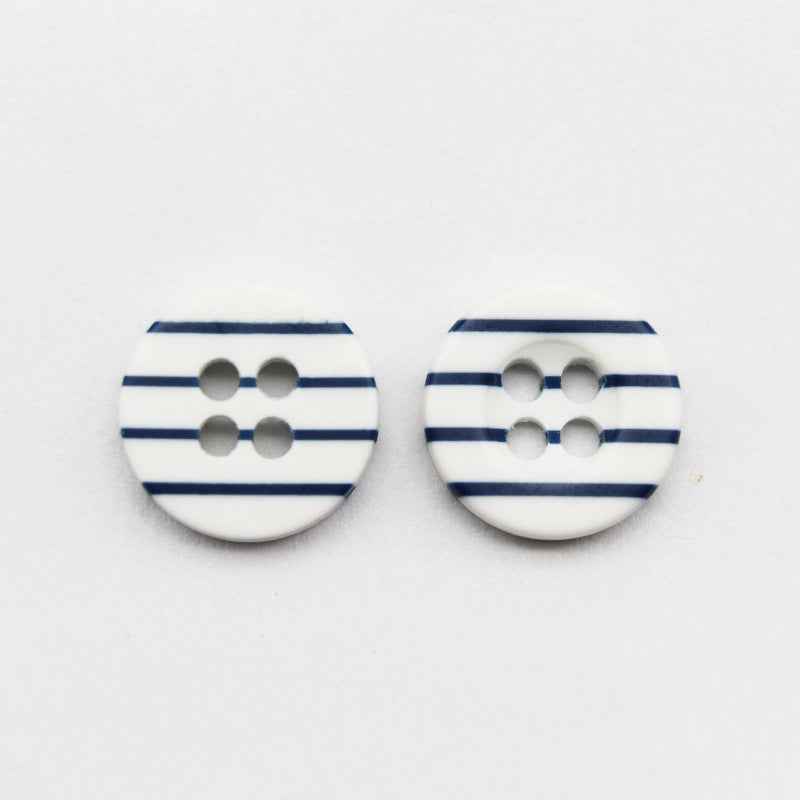 Pair of white resin buttons with navy horizontal stripes and four holes