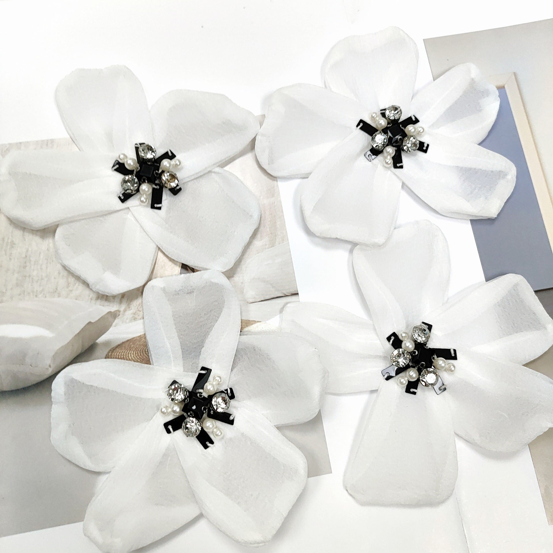 White organza chiffon flower appliques with rhinestone center and black ribbon bows