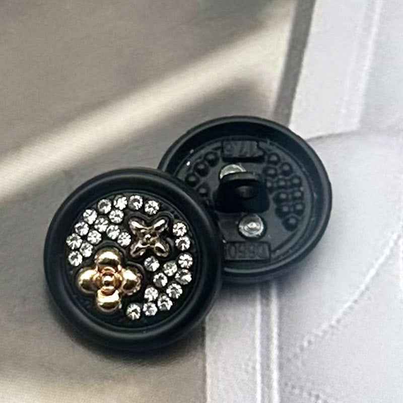 Black round metal shank button front, gold floral motif with clear rhinestones