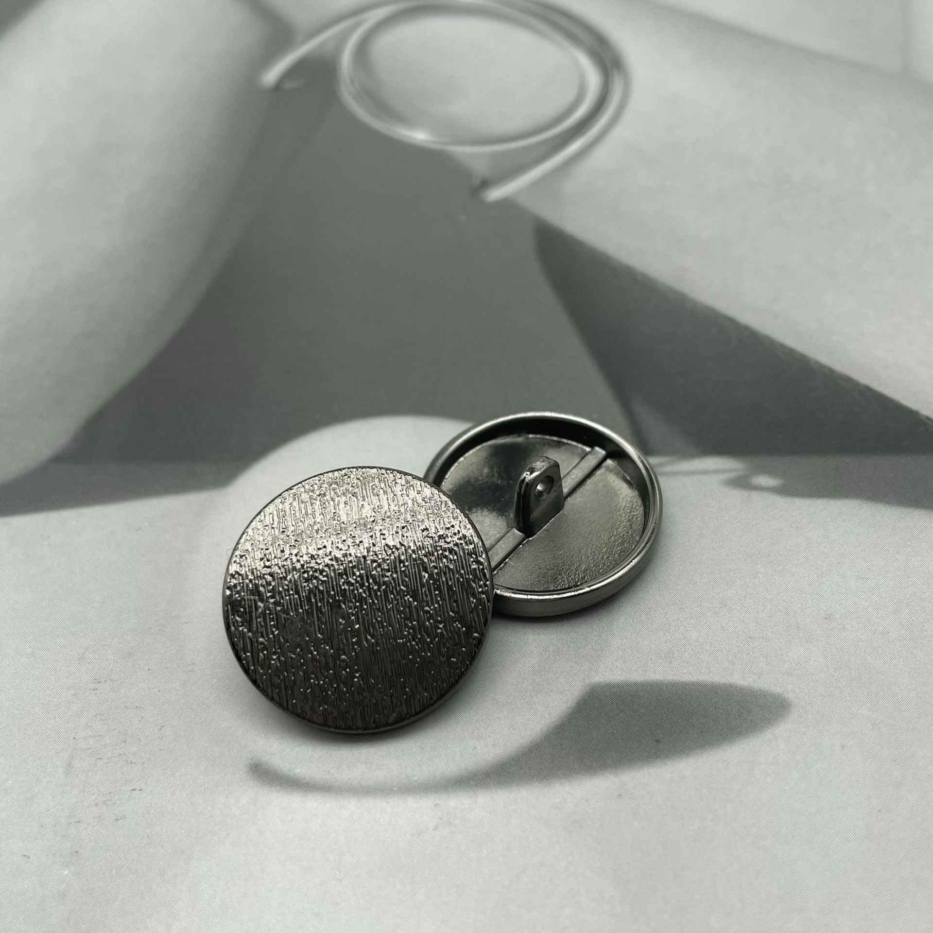 1-inch round matte metal shank button, gunmetal textured front with back