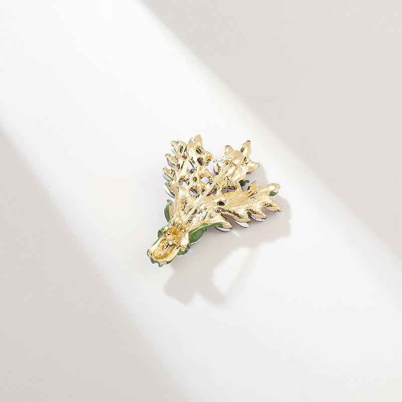 Gold-toned crystal brooch pin with curled leaf cluster