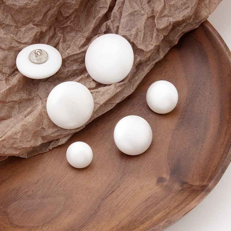 Assorted white round pearl buttons with metal shank, mix of sizes