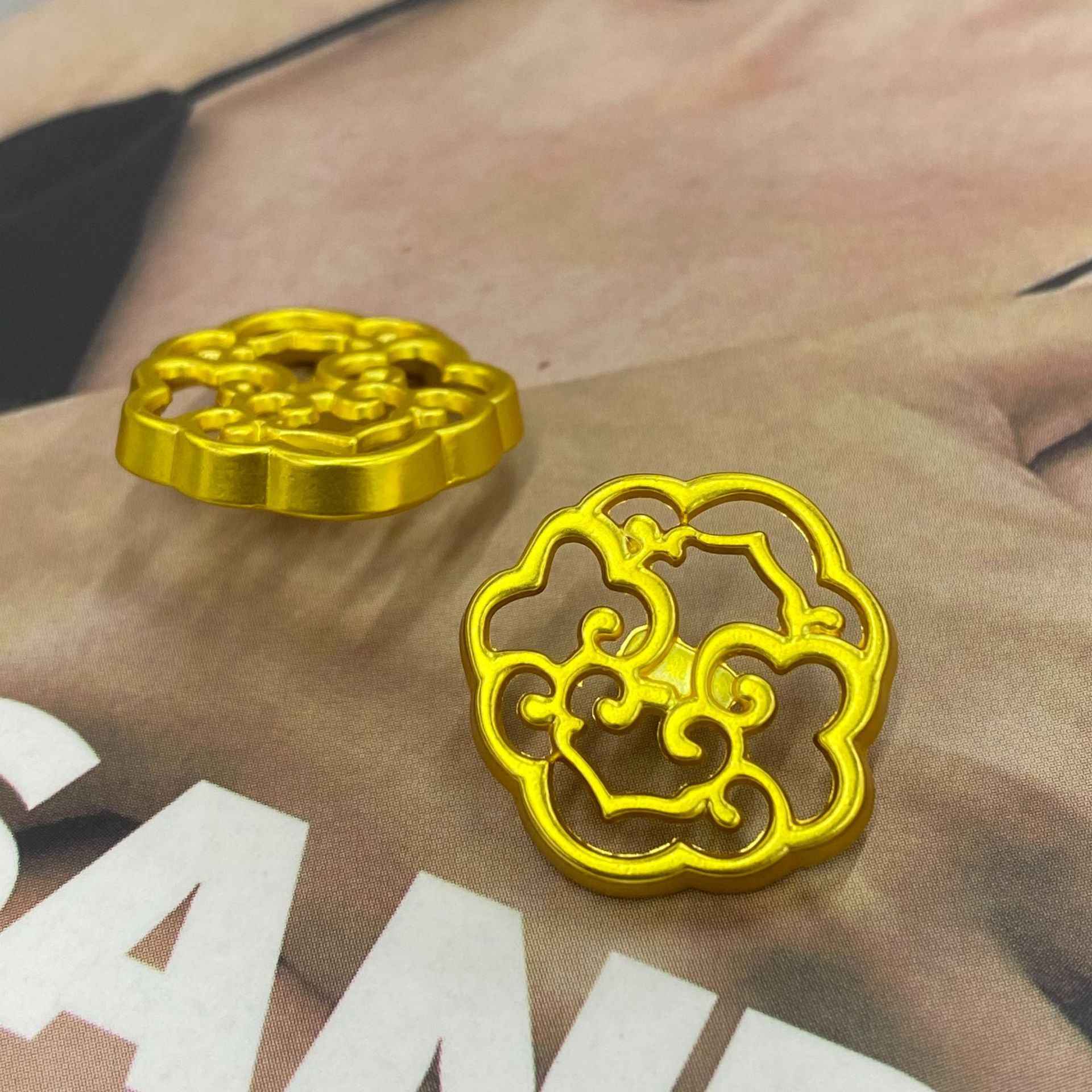 Gold decorative metal shank button, hollow pattern center, side view