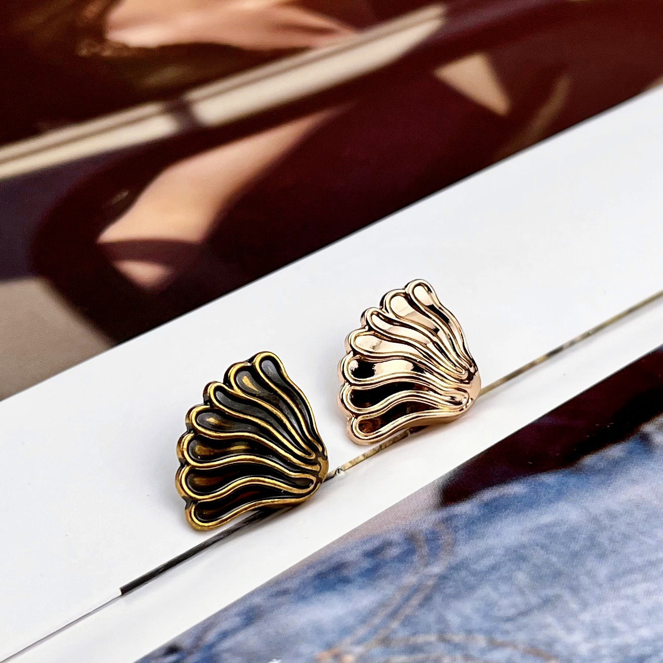 Two gold-tone fan coat buttons, ridged scalloped metal face with shank