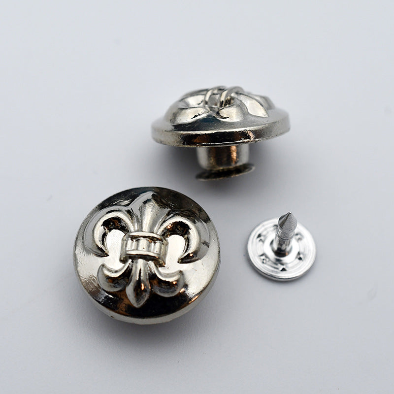 Round metal shank stud button with fleur-de-lis metal emblem detail