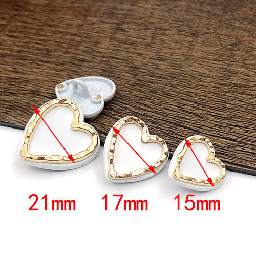 White heart-shaped metal shank button with gold trim, 21 mm