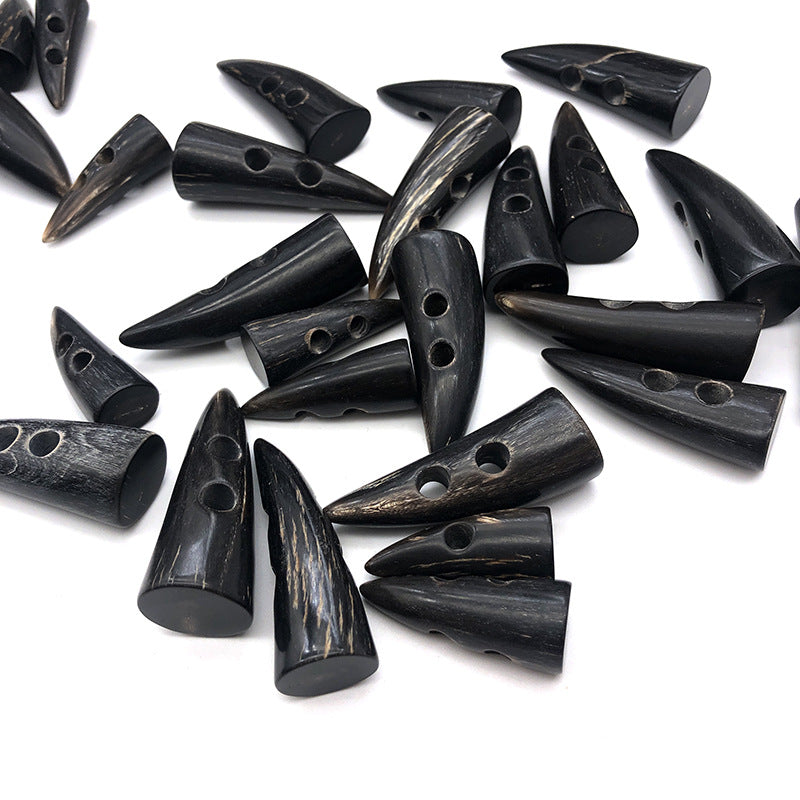 Set of dark horn-look toggle buttons with pointed oval shapes and multiple eyelets