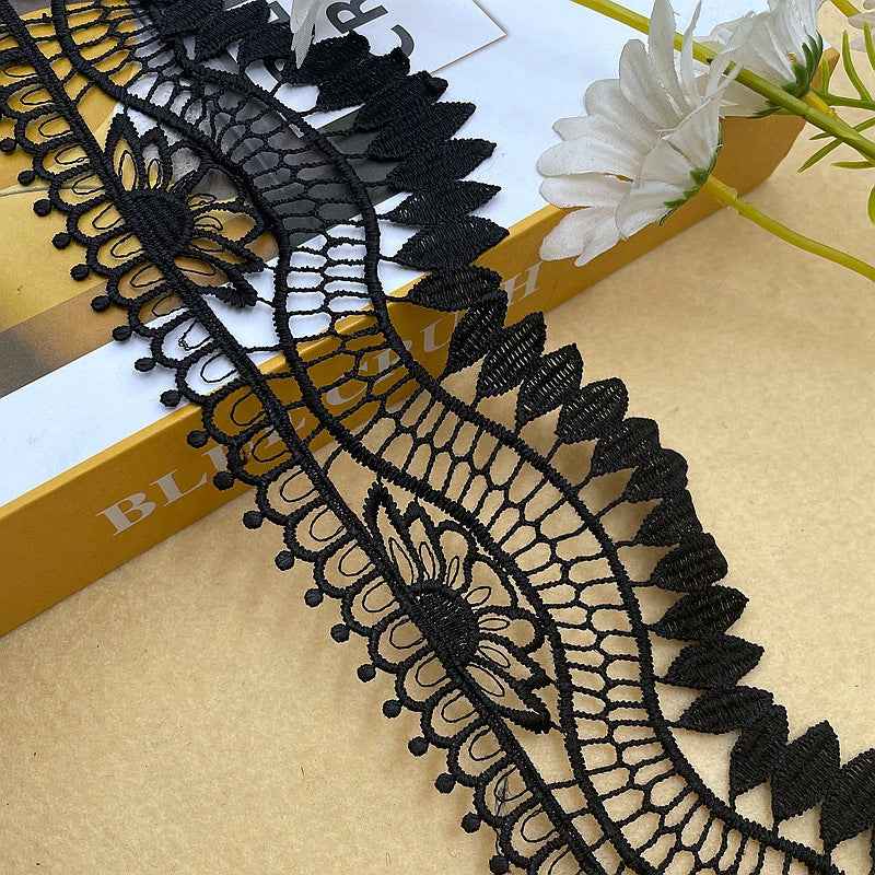 Black 10 cm lace trim featuring net mesh arcs and ornate floral centers