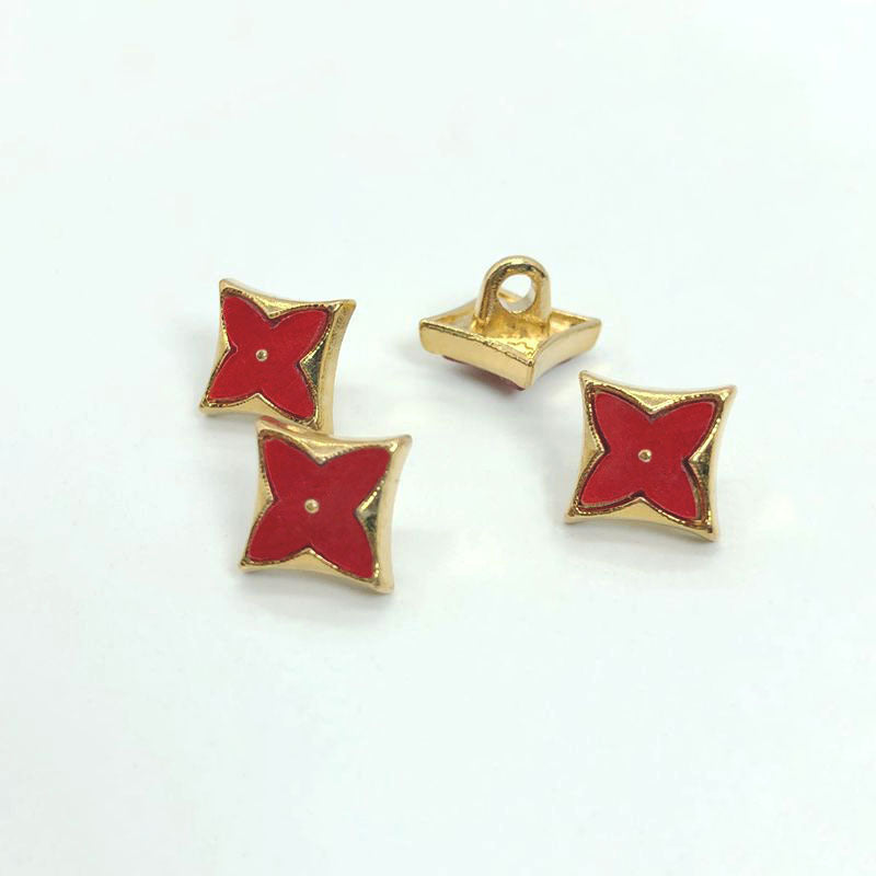 Red enamel rhombus four-leaf clover shirt buttons with gold rim, metal shank; one viewed from back