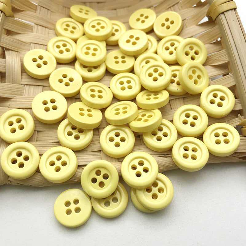 11.5mm round four-hole buttons in light yellow and pale cream tones.