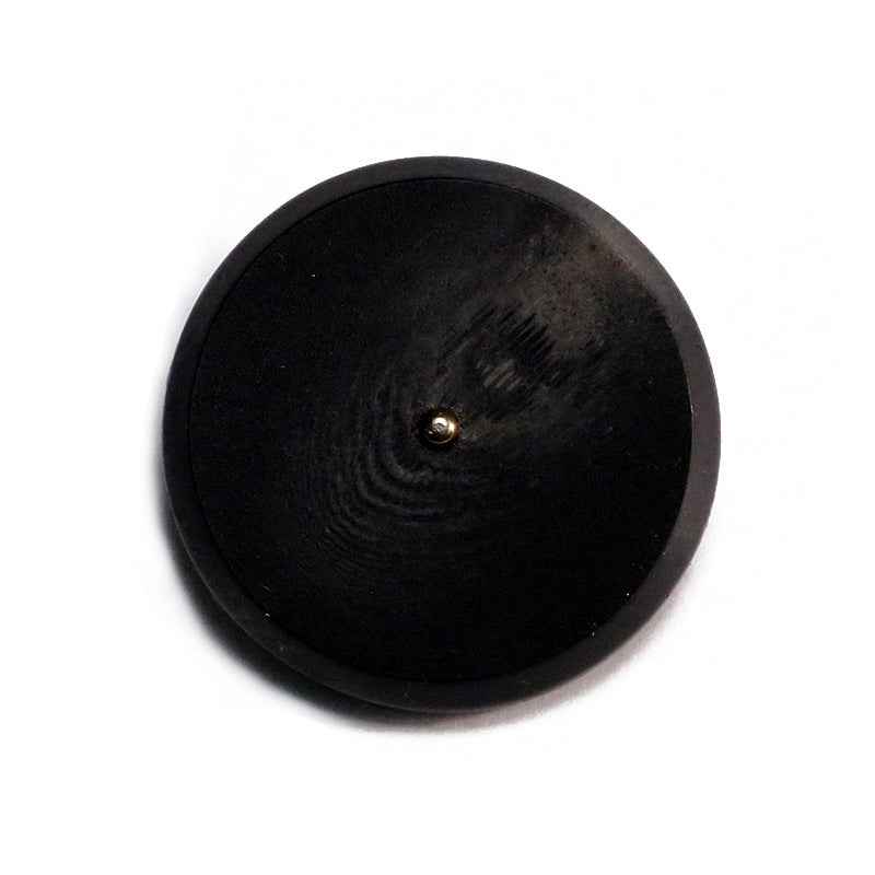 Black round resin button with flat face and metal shank, visible button post