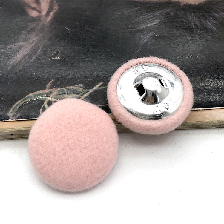 Two 28mm fabric-covered buttons: light pink textile face with silver metal snap