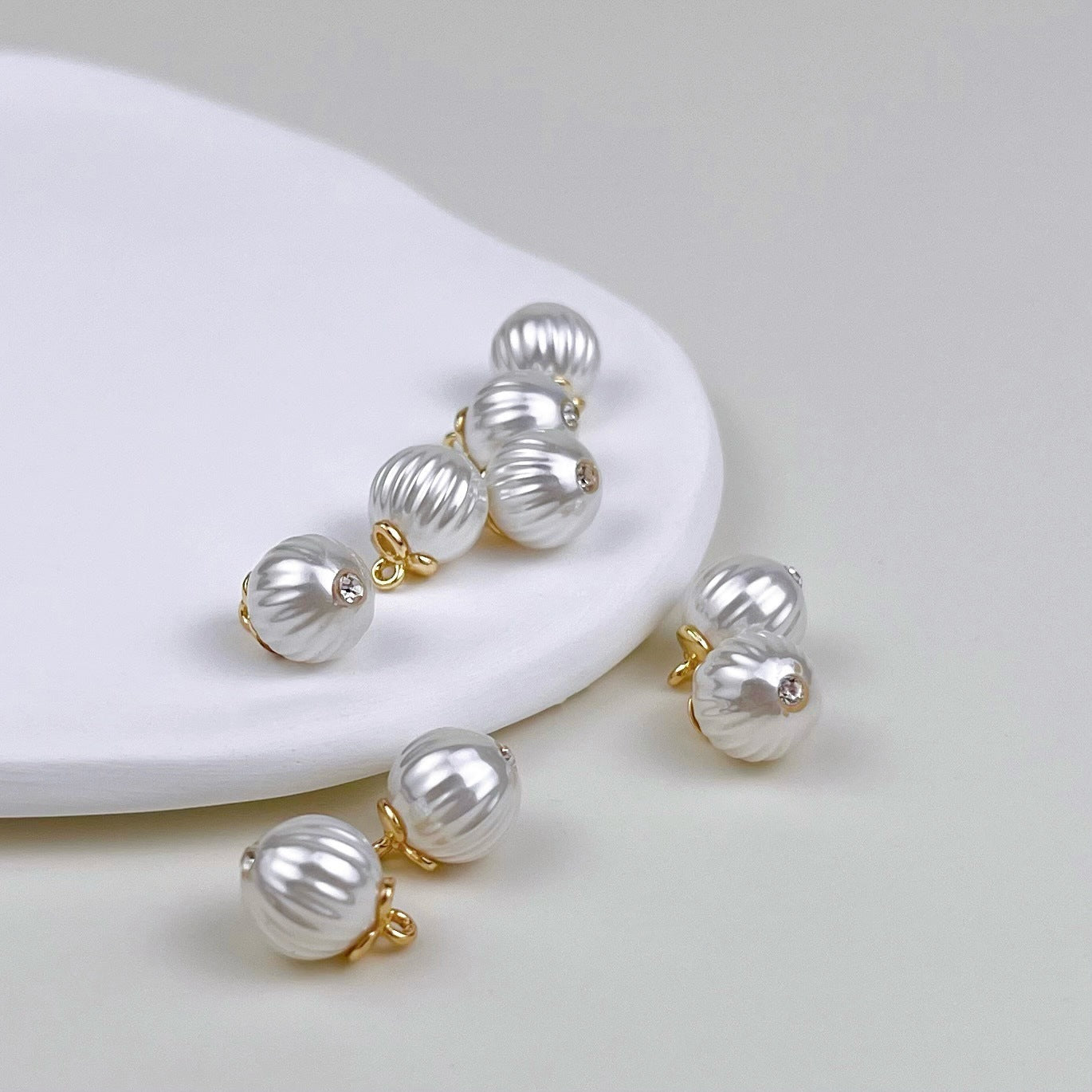 Baroque pearl-shaped metal buttons: silver ribbed rounds with gold ring tops
