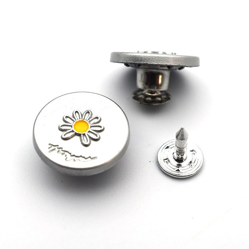 Round metal shank stud button with daisy flower design, yellow center