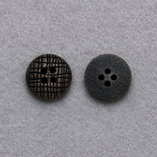 Two dark brown flat round wood buttons with four-hole designs