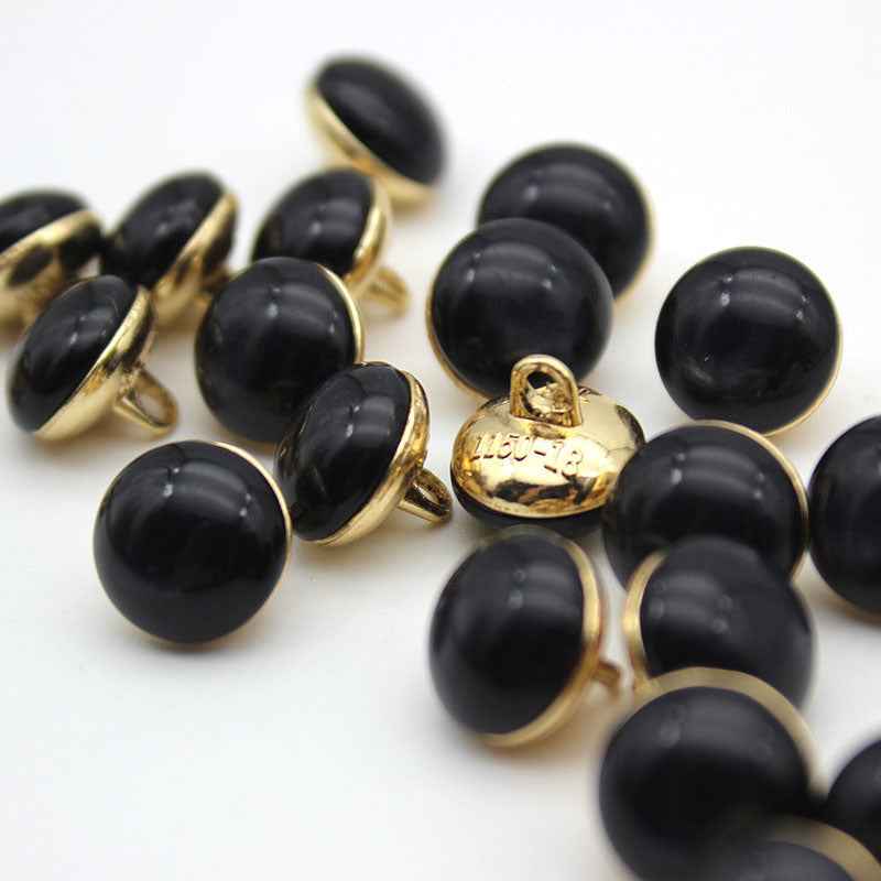 Black cat-eye shank buttons with gold loop backs, round, mixed set