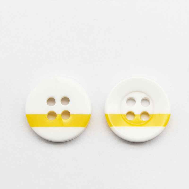 White round resin button with four holes and yellow stripe across the front