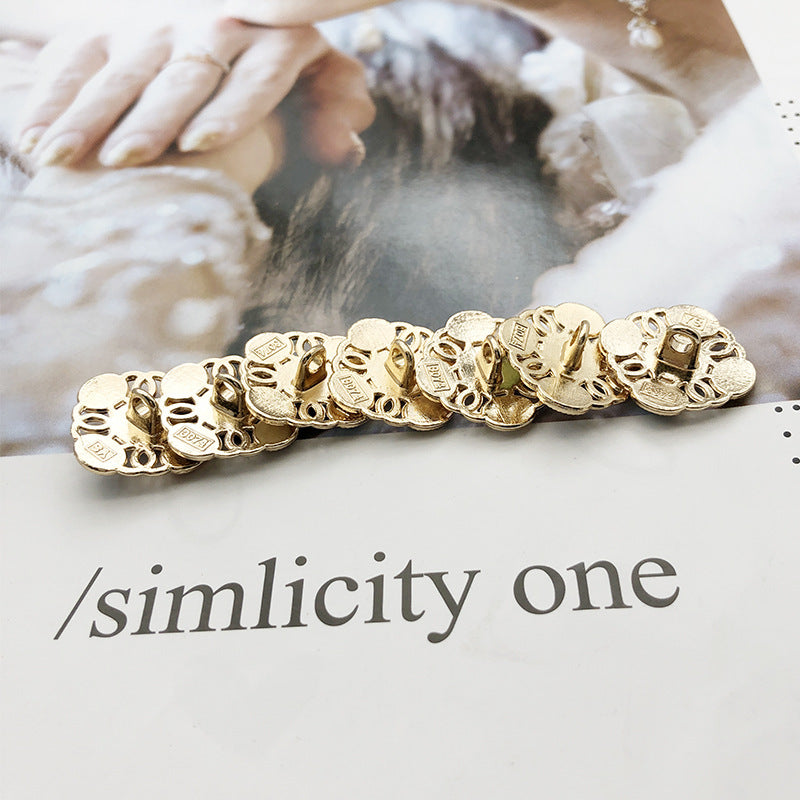 Square metal shank pearl buttons with white round pearl centers and gold-tone frame