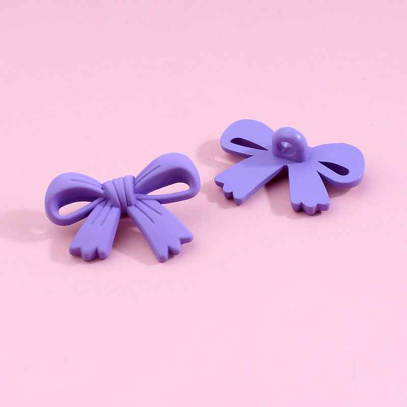 Purple bow-shaped plastic shank buttons with loop shanks, 2-piece view