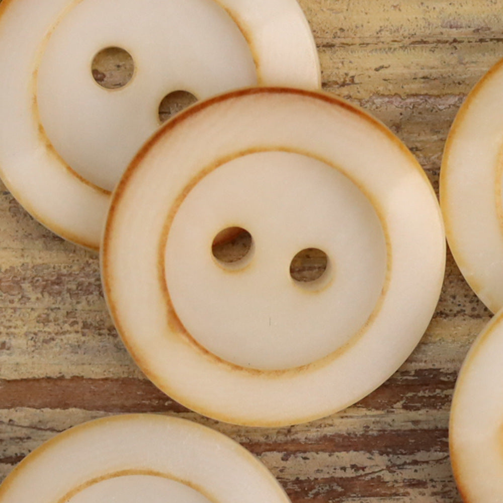 Cream round 2-hole buttons with warm rim edge and textured palm nut finish