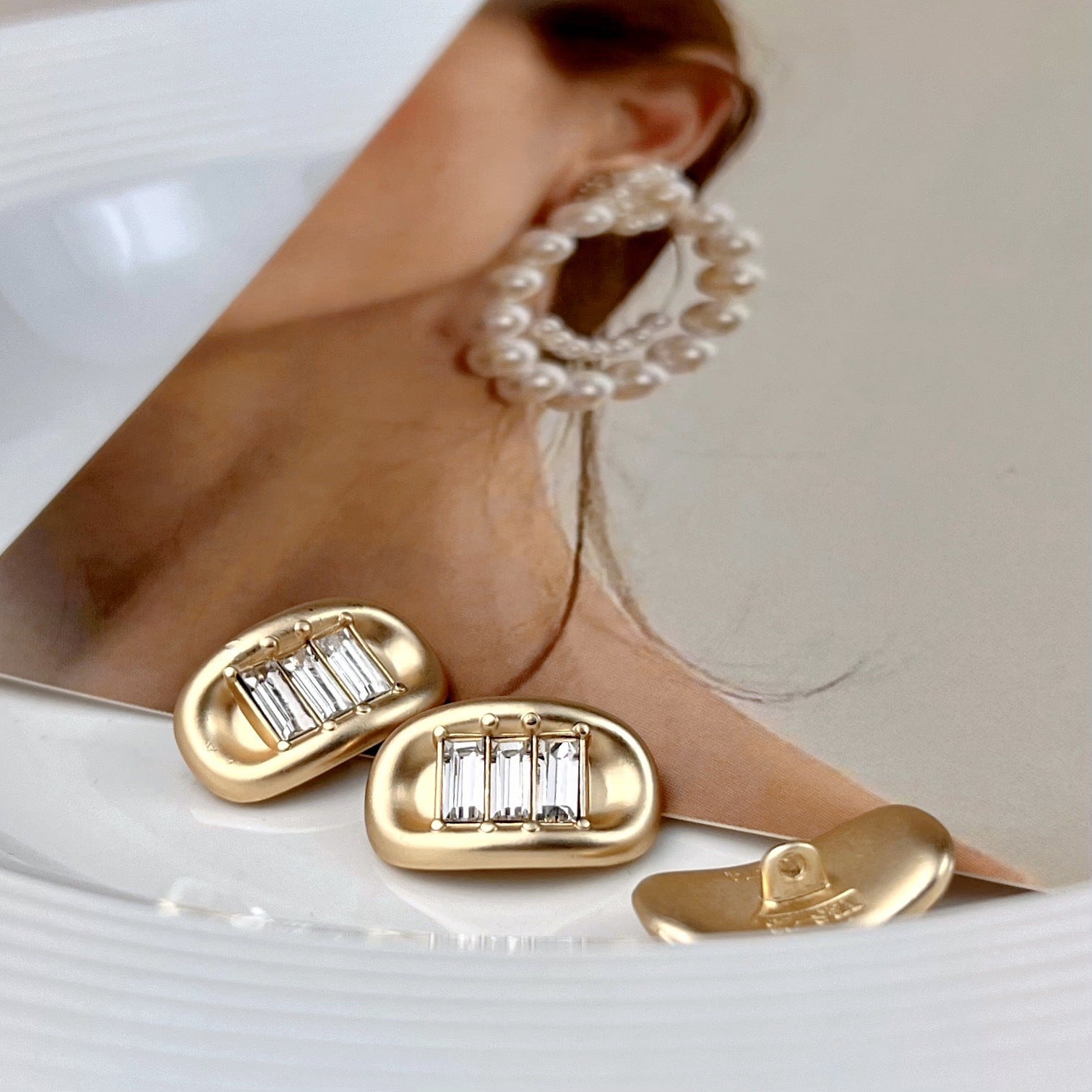 Light gold ingot rhinestone metal shank button, oval frame with baguette stones