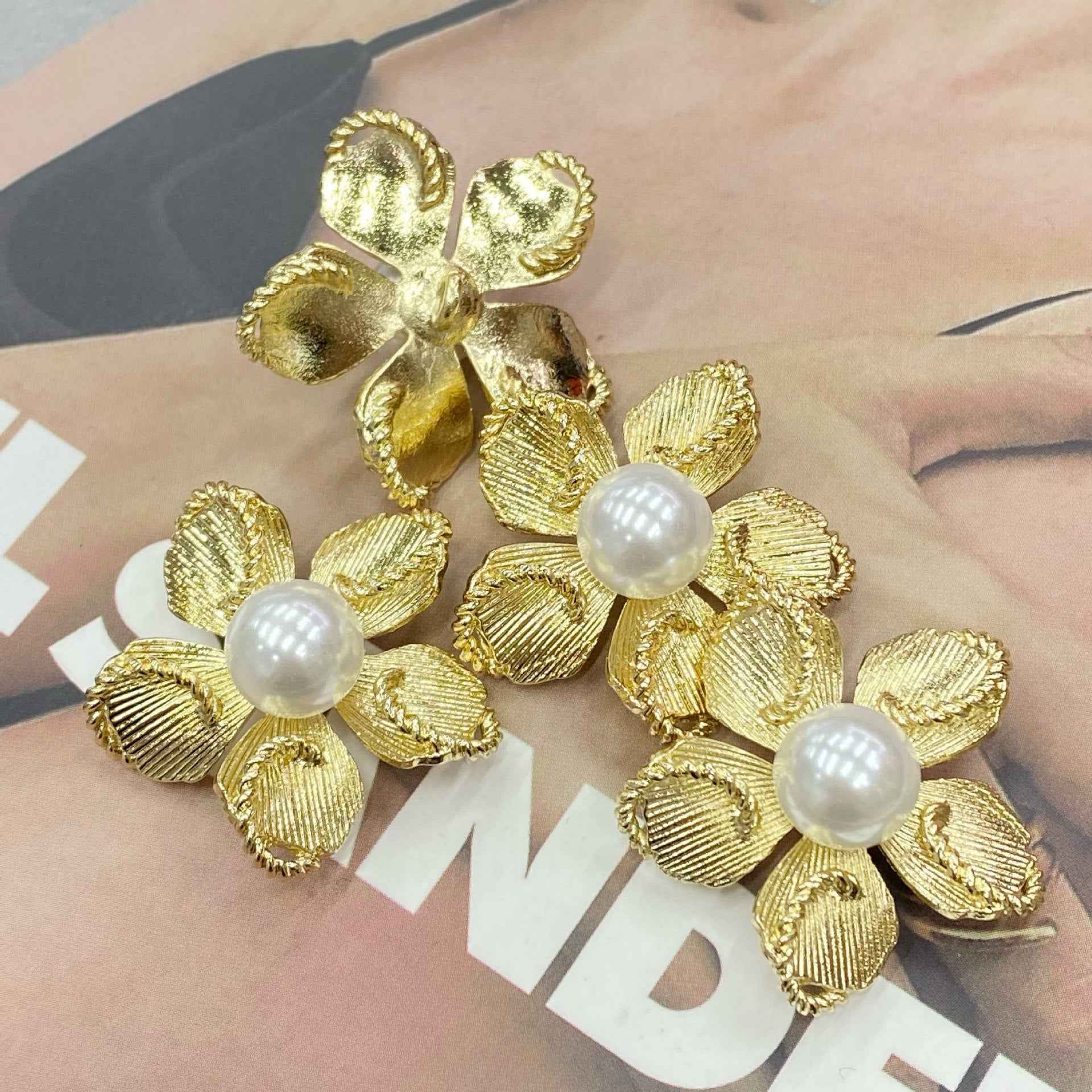 Gold 3D flower shank buttons with white pearl-like centers, 30mm