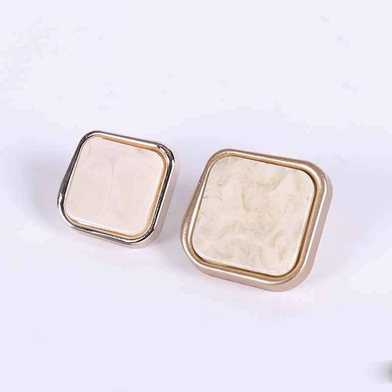 Rose gold square beveled plastic buttons with light marble finish, front view pair