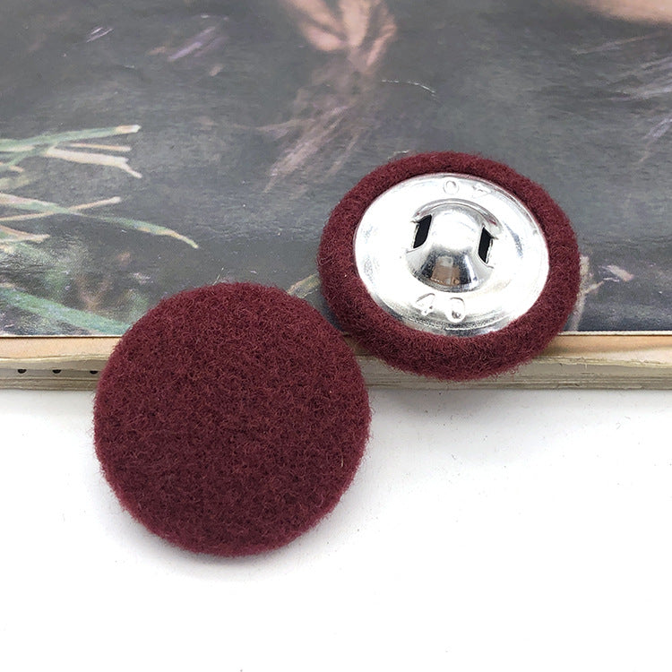 Two 28mm fabric-covered buttons: burgundy textile face with silver metal snap