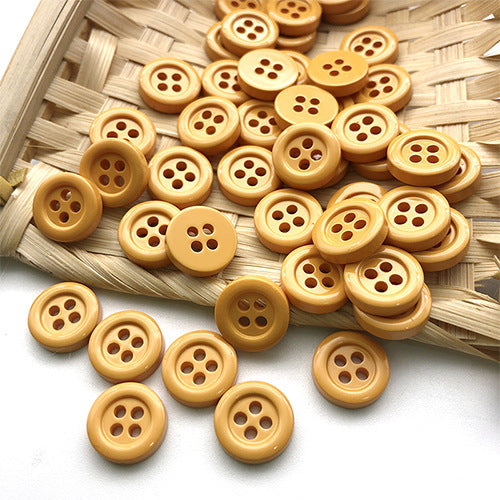 11.5mm round four-hole buttons in warm tan and gold tones.