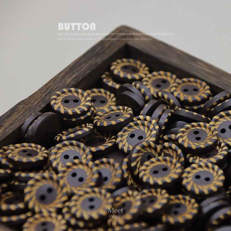 Pile of 15mm dark brown round wood buttons with yellow striped swirl, two holes