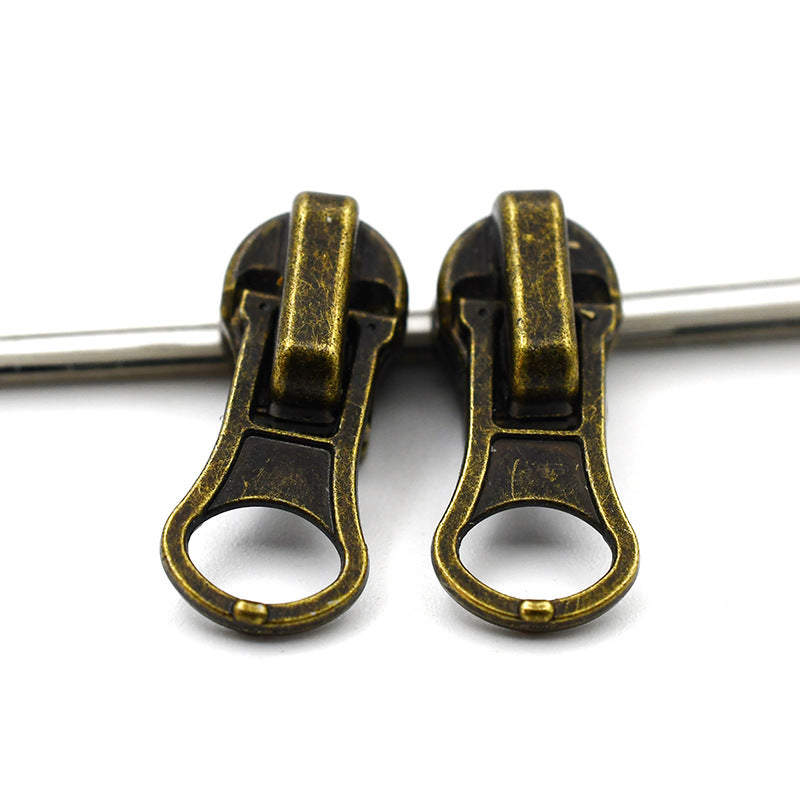 Two heavy-duty metal zipper pulls (#4) in antique brass finish, round ring tab