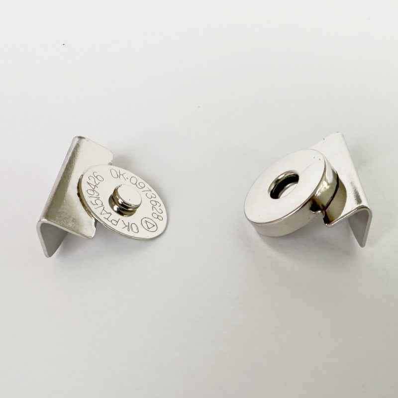 Silver magnetic clasp close-up: clip half with tab and round magnet half with hole