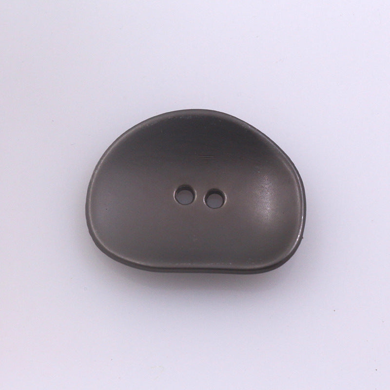 Irregular two-hole metal button, dark gray finish, rounded oval shape