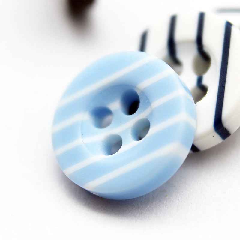 Light blue striped resin button with four holes