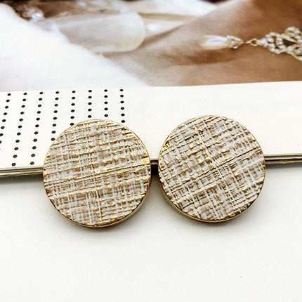 Pair of round coat buttons on metal pin, light beige striped pattern