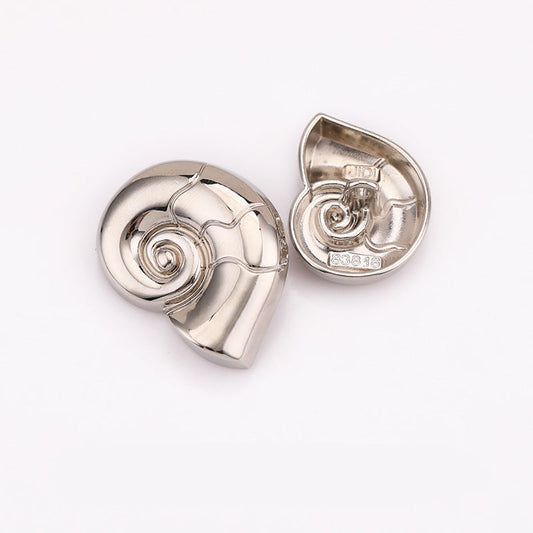 Snail-shaped metal shank button, nickel silver finish with spiral detail