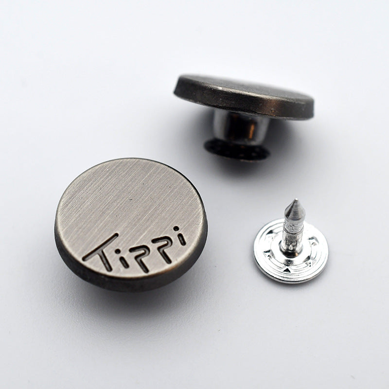 Round metal shank stud button with “KAR” style engraved letters