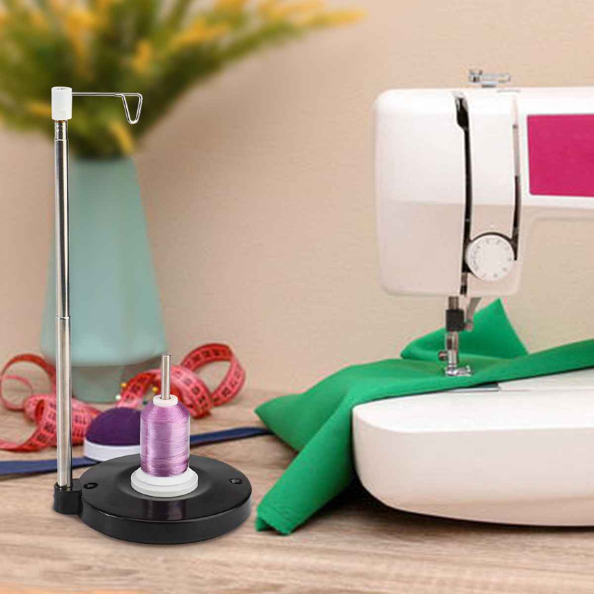 Thread spool cone holder with purple spool on black base, metal support pole