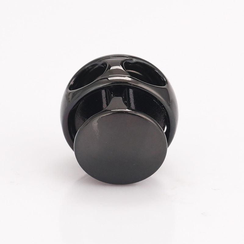 Dark ball-shaped metal spring toggle stopper, rear side with mounting loop visible