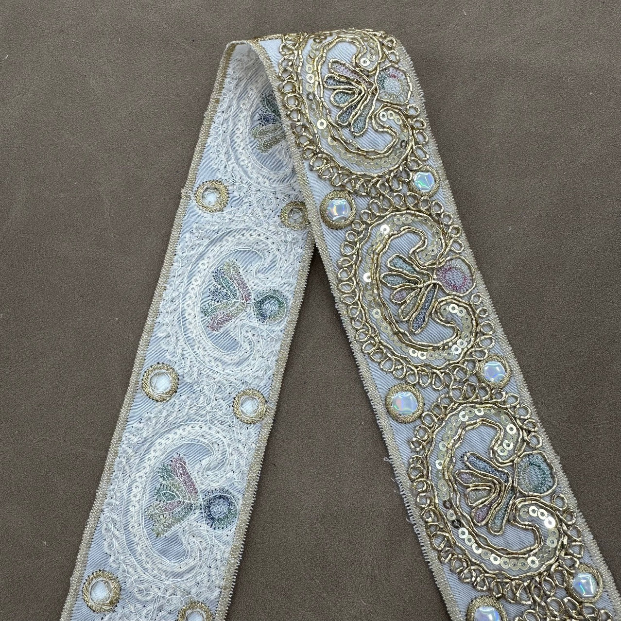 Light blue embroidered trim with paisley motifs, sequins, and gold bead accents