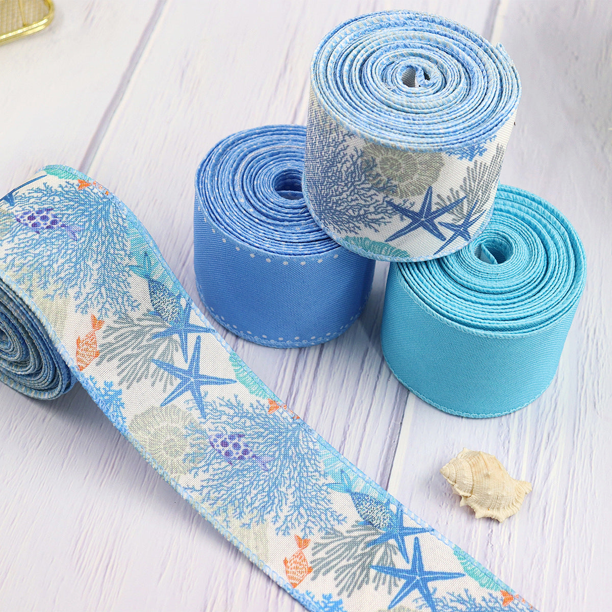 Coiled 63mm blue coral reef grosgrain ribbon rolls with wire edge, stacked 4-pack