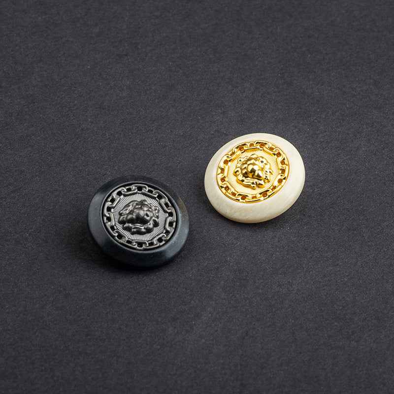 Two lion resin-metal buttons: black with silver crest and beige with gold crest